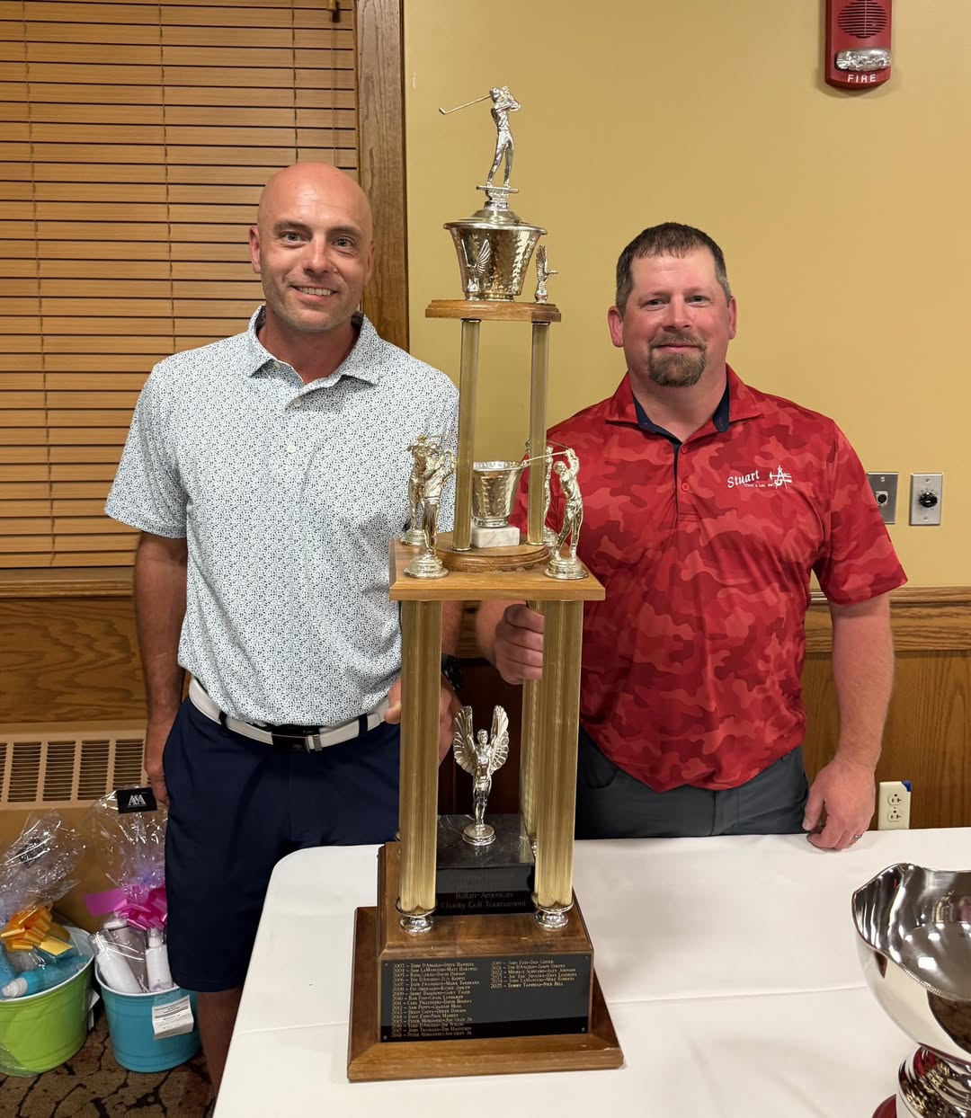 Casey Digirolamo and PJ Degnan holding the 2026 Italian-American Charity Golf champions trophy