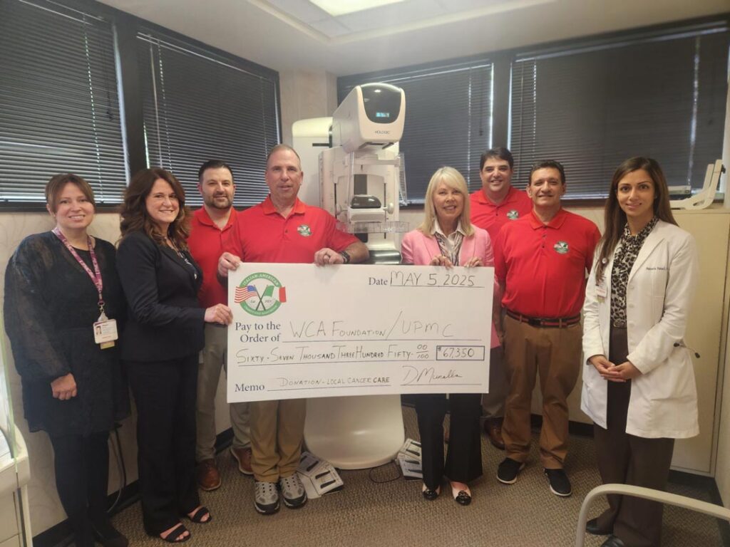 IA committee members presenting a foundation donation check in May 2025